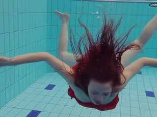 Rot angezogen teenager schwimmen mit sie augen opened